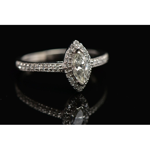 23 - A PLATINUM DIAMOND HALO RING, centring on a marquise cut diamond, estimated diamond weight 0.50cts, ... 