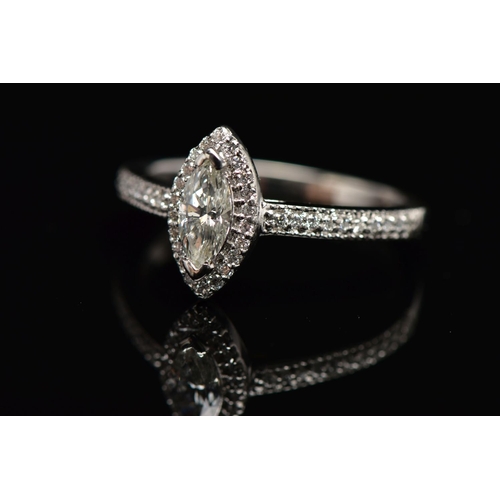 23 - A PLATINUM DIAMOND HALO RING, centring on a marquise cut diamond, estimated diamond weight 0.50cts, ... 