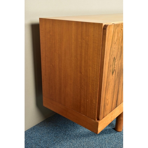 348 - GORDON RUSSELL (BRITISH 1892-1980) A 1960'S ROSEWOOD AND TEAK 7FT SIDEBOARD, the six doors with book... 