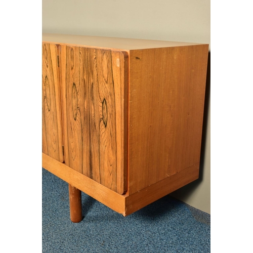 348 - GORDON RUSSELL (BRITISH 1892-1980) A 1960'S ROSEWOOD AND TEAK 7FT SIDEBOARD, the six doors with book... 