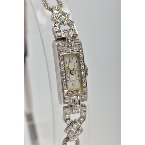 35 - AN EARLY TWENTIETH CENTURY DIAMOND COCKTAIL WATCH, a rectangular diamond case, measuring 23.0mm x 11... 