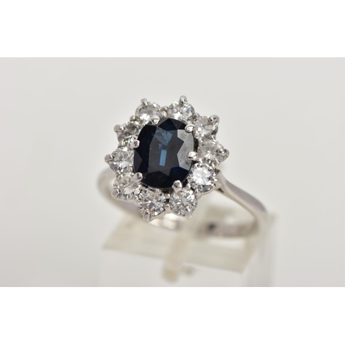 4 - AN 18CT WHITE GOLD, SAPPHIRE AND DIAMOND CLUSTER RING, set with a cushion-shaped mixed-cut sapphire,... 