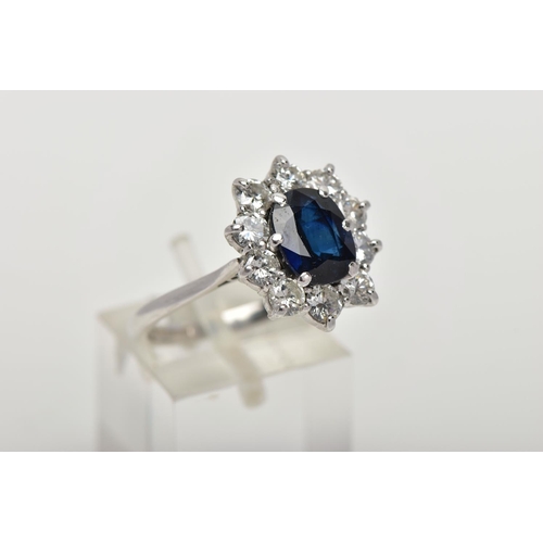 4 - AN 18CT WHITE GOLD, SAPPHIRE AND DIAMOND CLUSTER RING, set with a cushion-shaped mixed-cut sapphire,... 