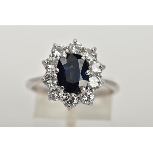 4 - AN 18CT WHITE GOLD, SAPPHIRE AND DIAMOND CLUSTER RING, set with a cushion-shaped mixed-cut sapphire,... 