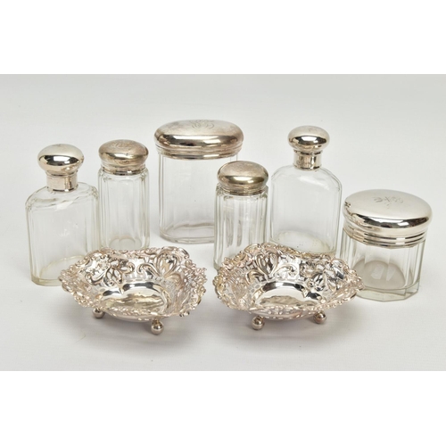 54 - A PAIR OF LATE VICTORIAN SILVER HEART SHAPED BONBON DISHES AND SIX SILVER TOPPED GLASS TOILET JARS, ... 