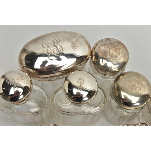 54 - A PAIR OF LATE VICTORIAN SILVER HEART SHAPED BONBON DISHES AND SIX SILVER TOPPED GLASS TOILET JARS, ... 