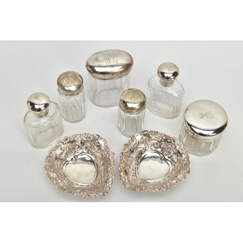 54 - A PAIR OF LATE VICTORIAN SILVER HEART SHAPED BONBON DISHES AND SIX SILVER TOPPED GLASS TOILET JARS, ... 