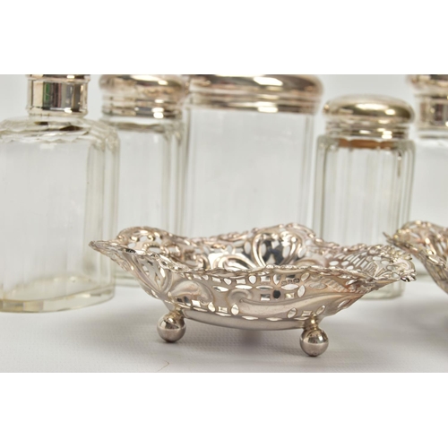 54 - A PAIR OF LATE VICTORIAN SILVER HEART SHAPED BONBON DISHES AND SIX SILVER TOPPED GLASS TOILET JARS, ... 