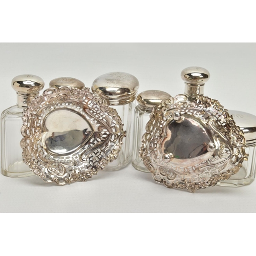 54 - A PAIR OF LATE VICTORIAN SILVER HEART SHAPED BONBON DISHES AND SIX SILVER TOPPED GLASS TOILET JARS, ... 