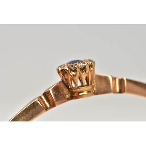 6 - AN EARLY TWENEITH CENTURY GOLD SAPPHIRE AND DIAMOND BANGLE, a yellow gold oval hinged bangle, set wi... 