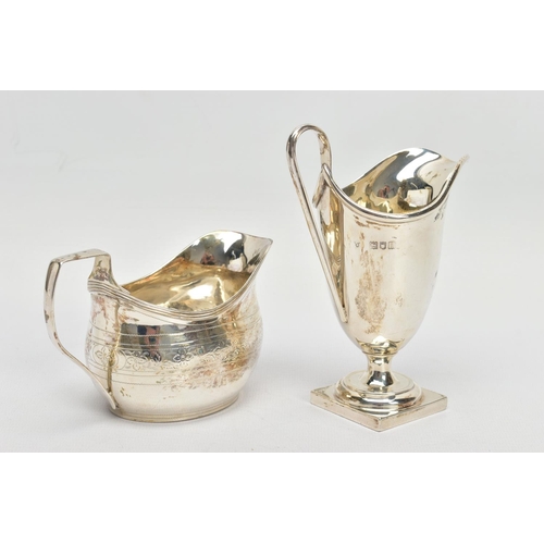 62 - TWO SILVER HELMET SHAPED CREAM JUGS, comprising a George III example with bright cut decoration, rec... 