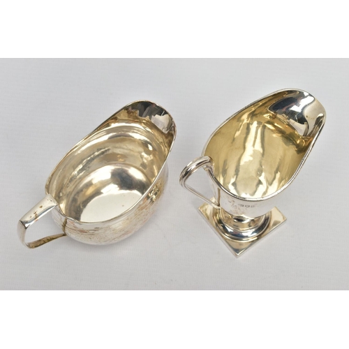 62 - TWO SILVER HELMET SHAPED CREAM JUGS, comprising a George III example with bright cut decoration, rec... 