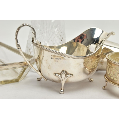 64 - A PARCEL OF SILVER AND SILVER MOUNTED ITEMS, comprising a George V sauce boat, on three cabriole leg... 