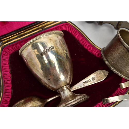 67 - A SMALL PARCEL OF SILVER, comprising a late Victorian seven bar toast rack of arched form, on four b... 