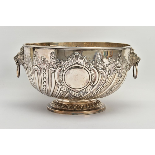 73 - A VICTORIAN SILVER PUNCH BOWL, with cast lion mask and ring handles, the bowl repousse decorated wit... 