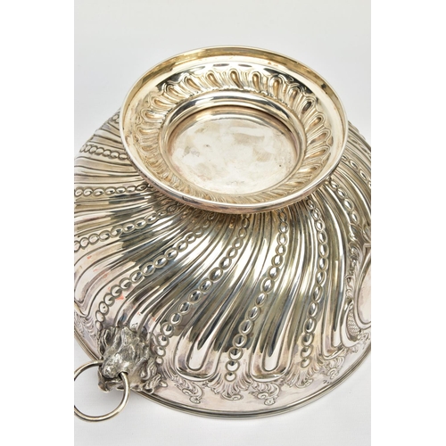 73 - A VICTORIAN SILVER PUNCH BOWL, with cast lion mask and ring handles, the bowl repousse decorated wit... 