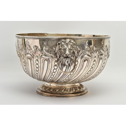 73 - A VICTORIAN SILVER PUNCH BOWL, with cast lion mask and ring handles, the bowl repousse decorated wit... 