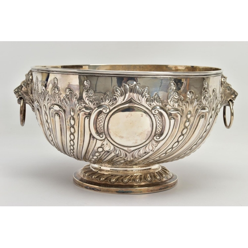 73 - A VICTORIAN SILVER PUNCH BOWL, with cast lion mask and ring handles, the bowl repousse decorated wit... 