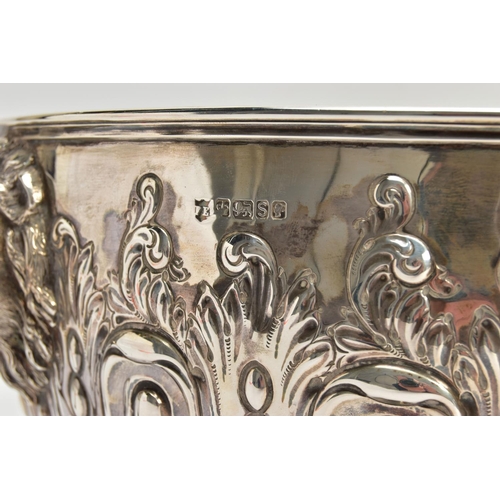 73 - A VICTORIAN SILVER PUNCH BOWL, with cast lion mask and ring handles, the bowl repousse decorated wit... 