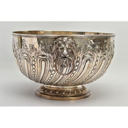 73 - A VICTORIAN SILVER PUNCH BOWL, with cast lion mask and ring handles, the bowl repousse decorated wit... 