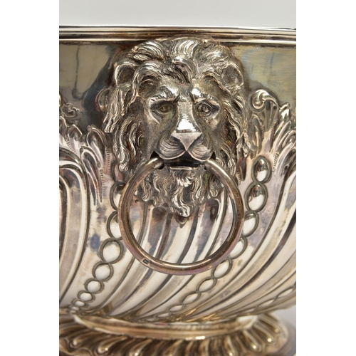 73 - A VICTORIAN SILVER PUNCH BOWL, with cast lion mask and ring handles, the bowl repousse decorated wit... 