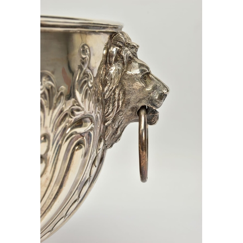 73 - A VICTORIAN SILVER PUNCH BOWL, with cast lion mask and ring handles, the bowl repousse decorated wit... 