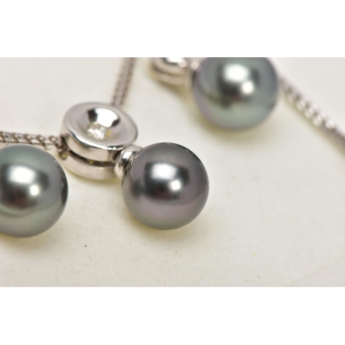 9 - A MODERN TAHITIAN PEARL AND DIAMOND PENDANT AND EARRING SET, pendant designed as a single articulate... 