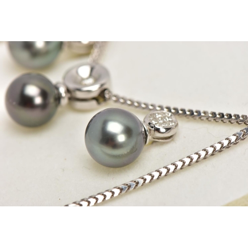 9 - A MODERN TAHITIAN PEARL AND DIAMOND PENDANT AND EARRING SET, pendant designed as a single articulate... 