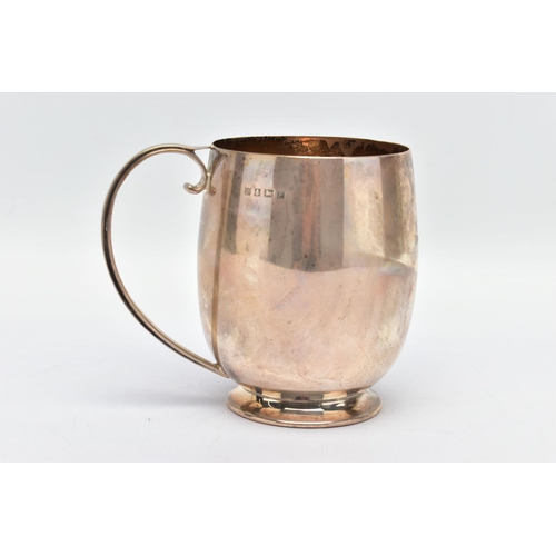 91 - AN ELIZABETH II SILVER MUG, a bell shaped mug with a scrolled handle and skirted foot, engraved 'M.C... 