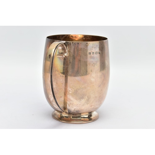 91 - AN ELIZABETH II SILVER MUG, a bell shaped mug with a scrolled handle and skirted foot, engraved 'M.C... 