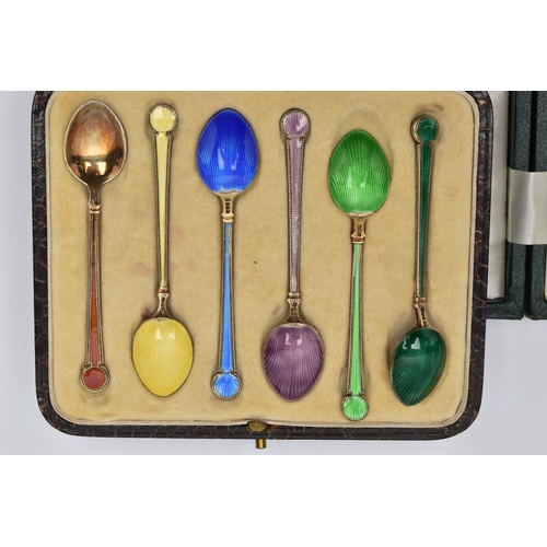 97 - A CASED SET OF SIX GEORGE V SILVER GILT AND HARLEQUIN ENAMEL COFFEE SPOONS, engine turned decoration... 