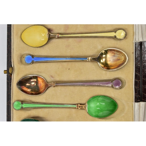 97 - A CASED SET OF SIX GEORGE V SILVER GILT AND HARLEQUIN ENAMEL COFFEE SPOONS, engine turned decoration... 