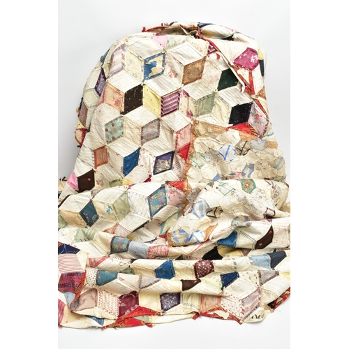 216 - A HAND STITCHED PATCHWORK QUILT, the geometric design incorporating fabrics which appear to be both ... 