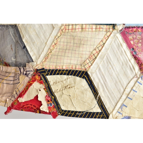 216 - A HAND STITCHED PATCHWORK QUILT, the geometric design incorporating fabrics which appear to be both ... 