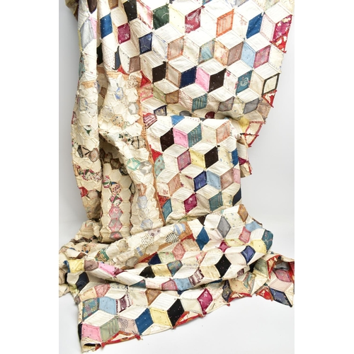 216 - A HAND STITCHED PATCHWORK QUILT, the geometric design incorporating fabrics which appear to be both ... 