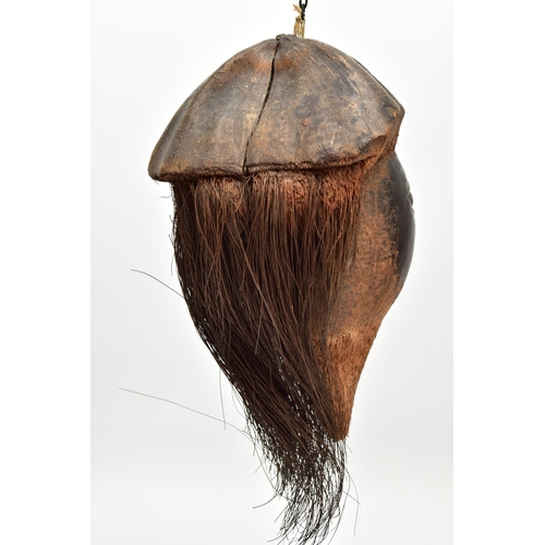 217 - A 19TH/ EARLY 20TH CENTURY CARVED COCONUT, the outer shell and husk forming hat and hair, the inner ... 