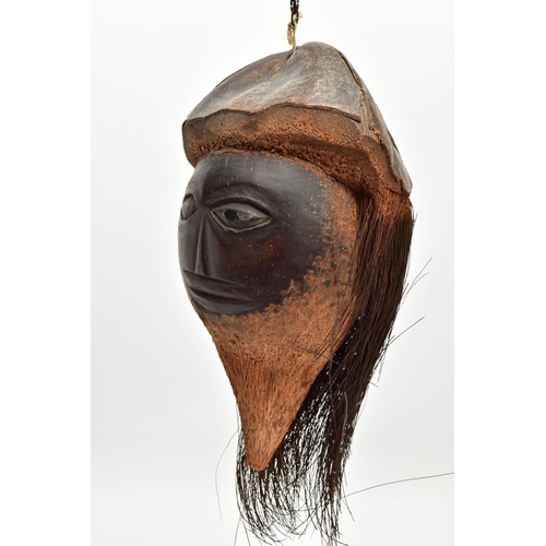 217 - A 19TH/ EARLY 20TH CENTURY CARVED COCONUT, the outer shell and husk forming hat and hair, the inner ... 