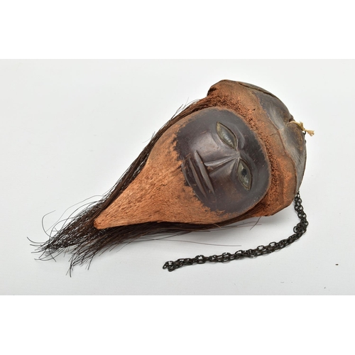 217 - A 19TH/ EARLY 20TH CENTURY CARVED COCONUT, the outer shell and husk forming hat and hair, the inner ... 