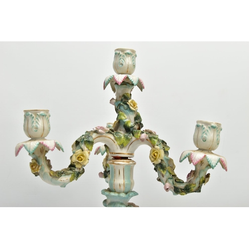 235 - A PAIR OF LATE 19TH / EARLY 20TH CENTURY PLAUE PORCELAIN FLORALLY ENCRUSTED FIGURAL CANDELABRA, each... 