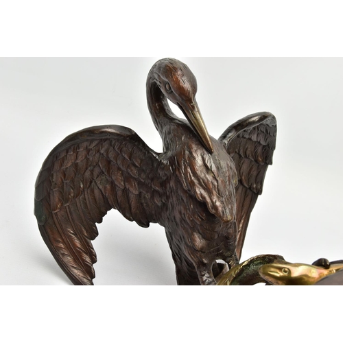 248 - A 19TH CENTURY BRONZE FIGURE OF A STORK STANDING WITH OUTSTRETCHED WINGS, clutching an eel to the gr... 