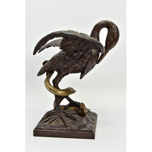 248 - A 19TH CENTURY BRONZE FIGURE OF A STORK STANDING WITH OUTSTRETCHED WINGS, clutching an eel to the gr... 