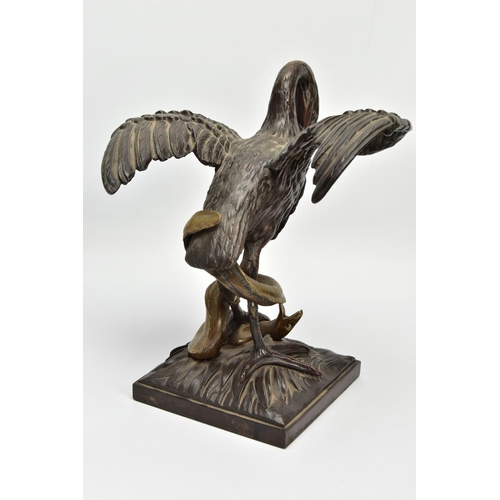 248 - A 19TH CENTURY BRONZE FIGURE OF A STORK STANDING WITH OUTSTRETCHED WINGS, clutching an eel to the gr... 