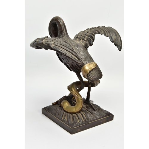 248 - A 19TH CENTURY BRONZE FIGURE OF A STORK STANDING WITH OUTSTRETCHED WINGS, clutching an eel to the gr... 