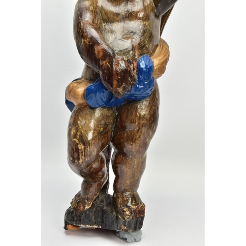 249 - A CARVED WOODEN SUPPORT IN THE FORM OF A PUTTI, with later polychrome decoration and later ebonised ... 