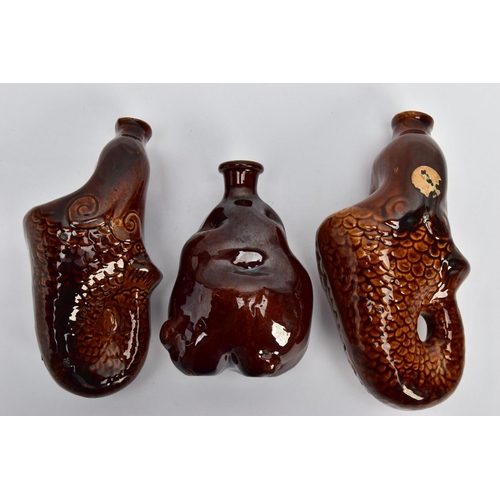 263 - TWO VICTORIAN TREACLE GLAZED FLASKS IN THE FORM OF MERMAIDS, heights 20cm and 18cm and another novel... 