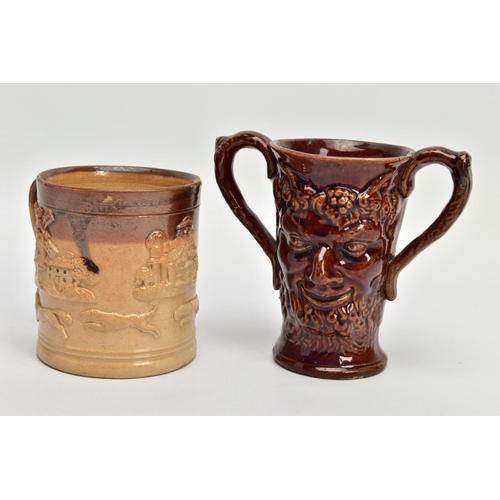 267 - A VICTORIAN TREACLE GLAZED LOVING CUP, decorated in relief with bust of Nelson, fighting dogs and ta... 