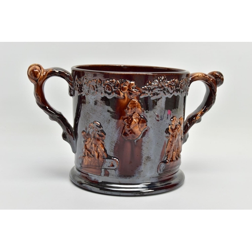 267 - A VICTORIAN TREACLE GLAZED LOVING CUP, decorated in relief with bust of Nelson, fighting dogs and ta... 