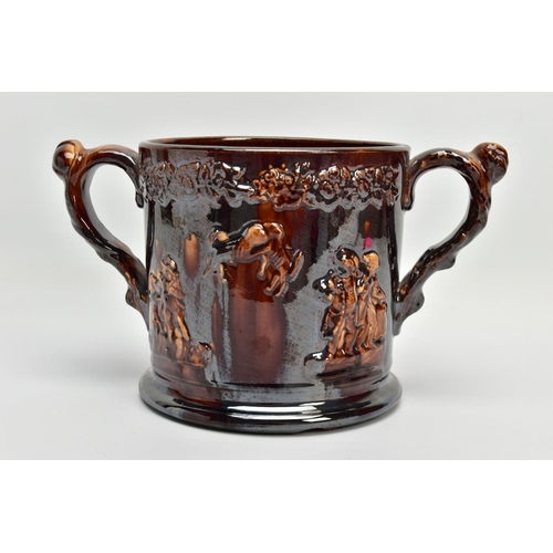 267 - A VICTORIAN TREACLE GLAZED LOVING CUP, decorated in relief with bust of Nelson, fighting dogs and ta... 