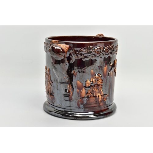 267 - A VICTORIAN TREACLE GLAZED LOVING CUP, decorated in relief with bust of Nelson, fighting dogs and ta... 