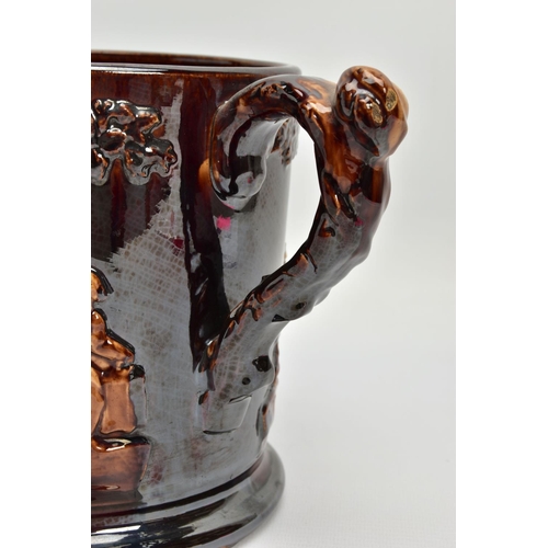 267 - A VICTORIAN TREACLE GLAZED LOVING CUP, decorated in relief with bust of Nelson, fighting dogs and ta... 